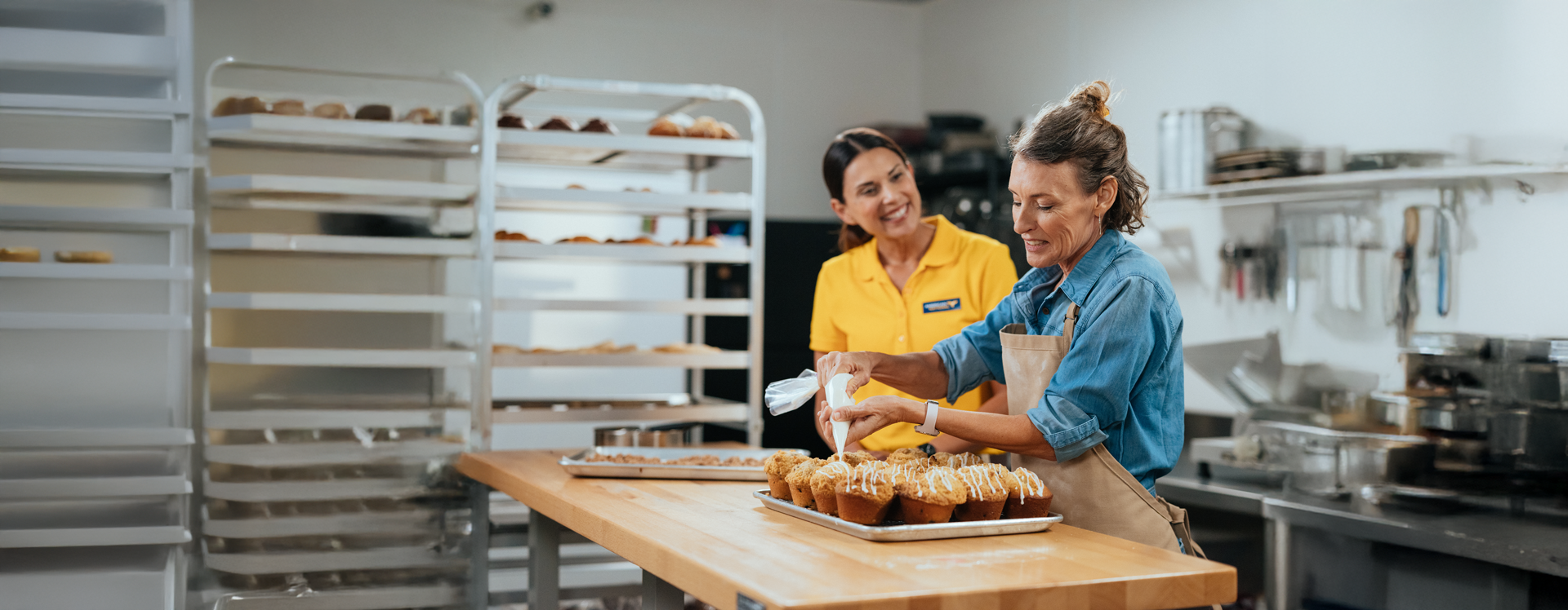 image of agent in the back of house at a bakery business with client.